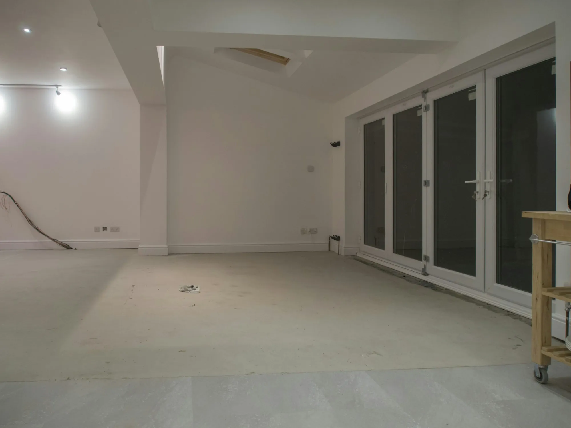 Empty room with new glass doors, cleared for remodeling work