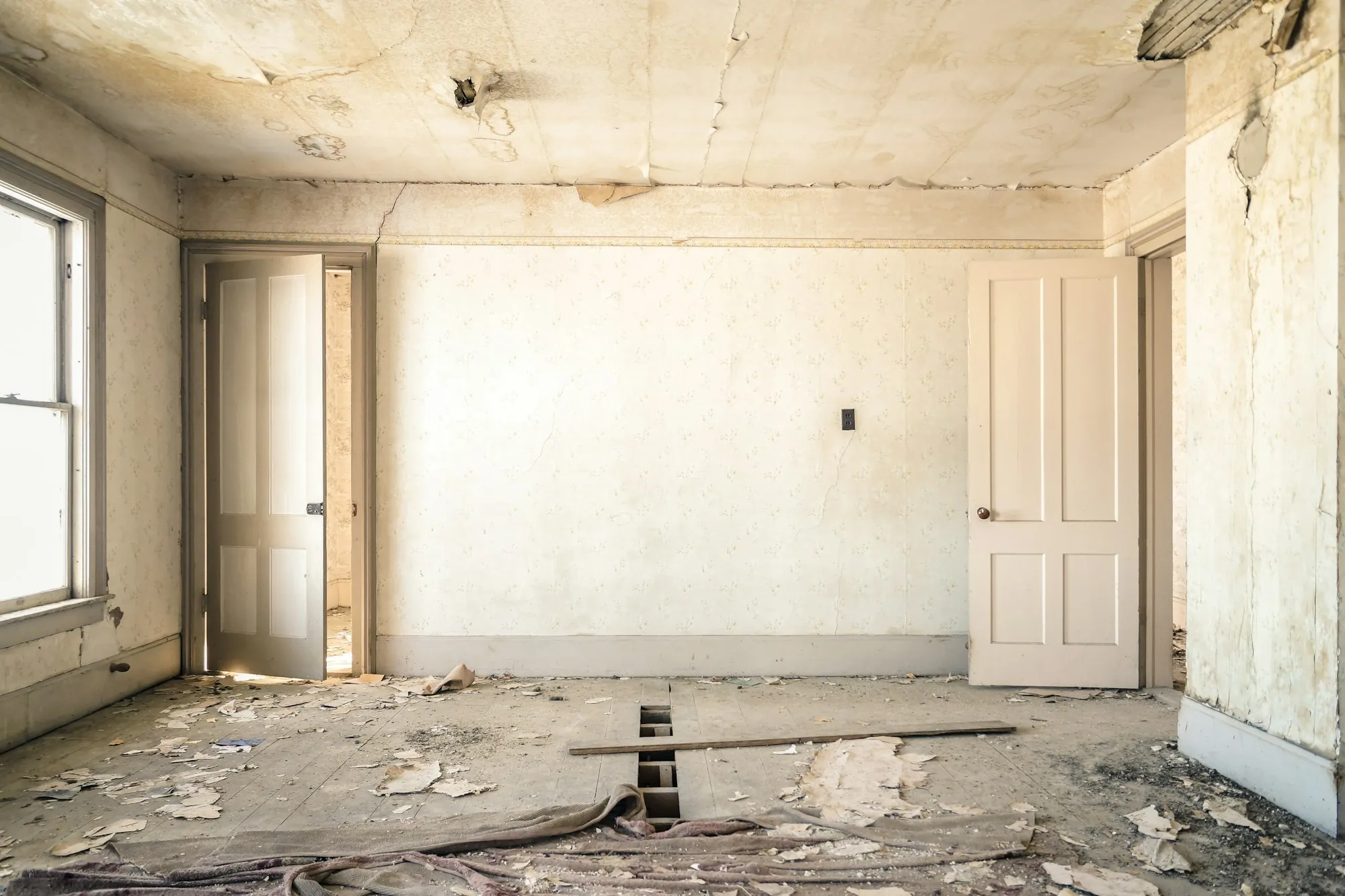 Room stripped to bare walls and subfloor before construction